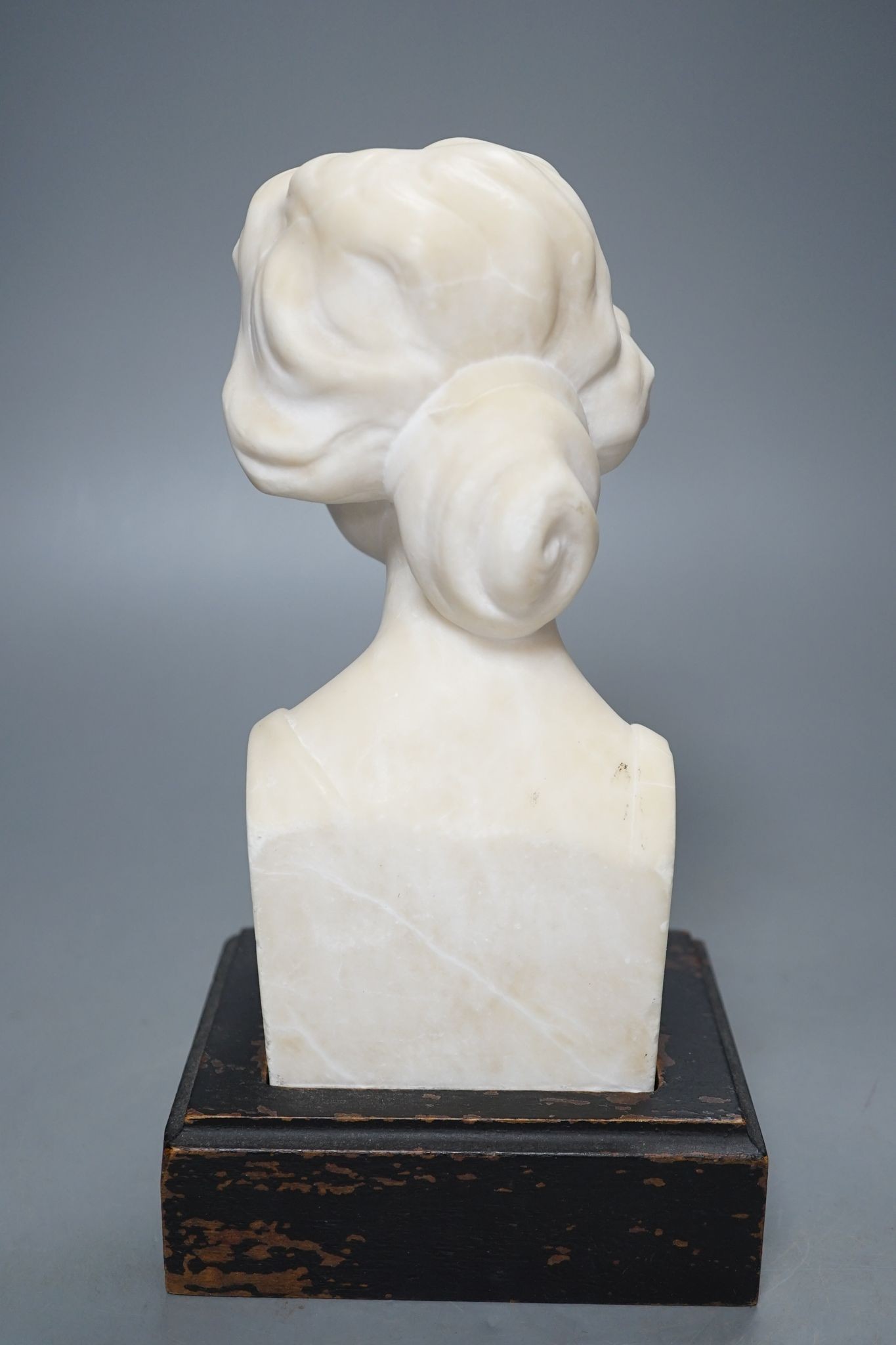 An alabaster head of a woman on plinth 25cm